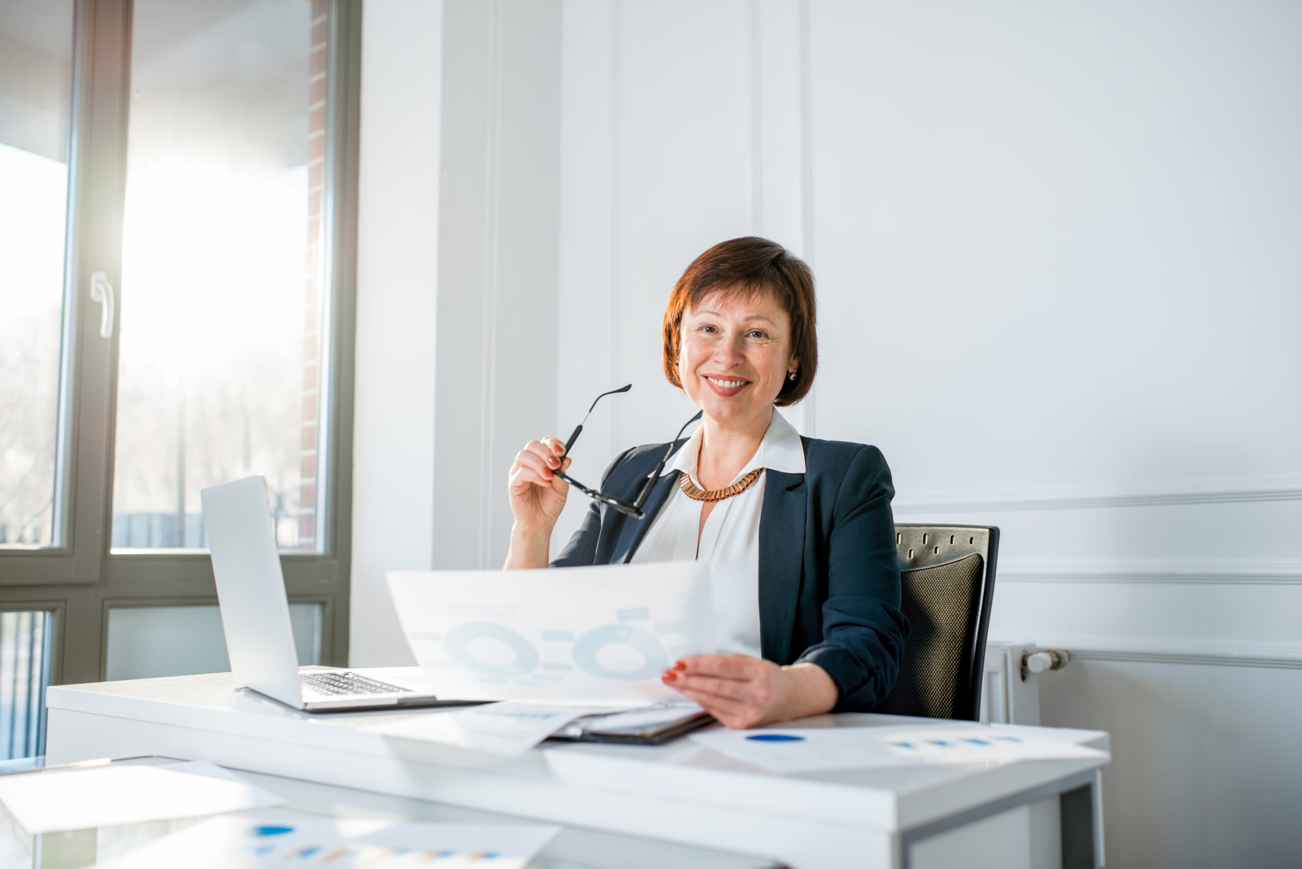 Étudiant universitaire parlant avec une enseignante dans la bibliothèque. Vie étudiante, adolescence, enseignement, éducation, mentorat, aide à l’apprentissage.